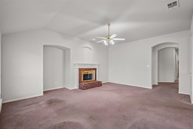 8709 Hartford Dr, Rowlett, TX 75089 - unfurnished living room with arched walkways, a ceiling fan, carpet flooring, a brick fireplace, and vaulted ceiling