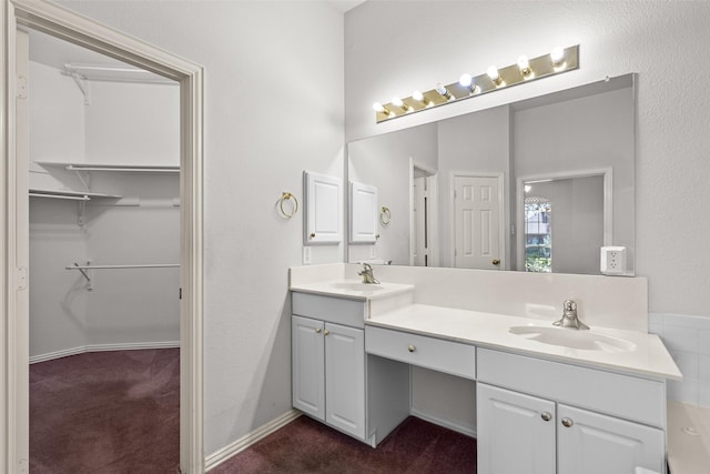8709 Hartford Dr, Rowlett, TX 75089 - bathroom with double vanity and a walk in closet
