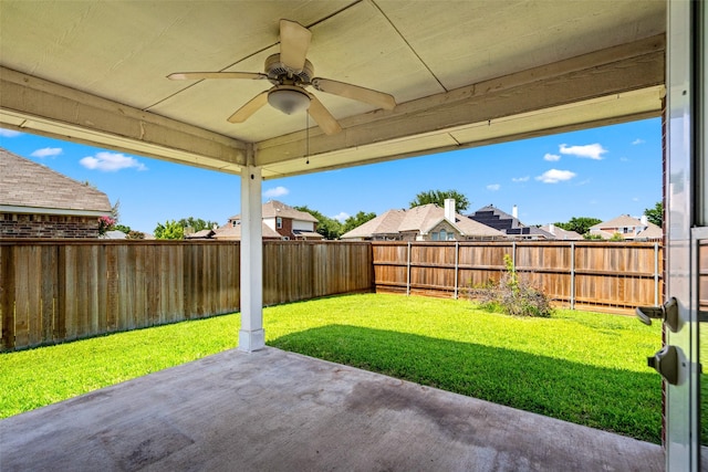8709 Hartford Dr, Rowlett, TX 75089 - fenced backyard featuring a patio area, a ceiling fan, and a residential view