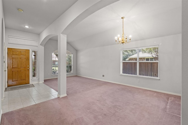8709 Hartford Dr, Rowlett, TX 75089 - carpeted entrance foyer featuring arched walkways, healthy amount of natural light, a chandelier, vaulted ceiling, and tile patterned floors