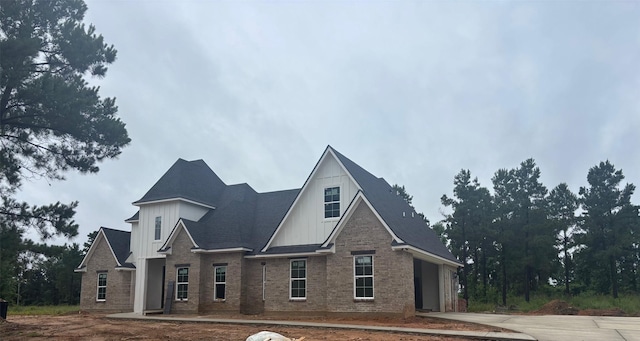 113 Faith Plantation Dr, Princeton, LA 71067 - view of front of property with board and batten siding, concrete driveway, and brick siding