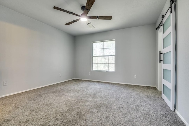 1004 Brae Loch Dr, Dallas, TX 75217 - empty room with a barn door, carpet floors, and a ceiling fan