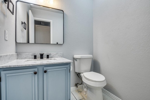 1004 Brae Loch Dr, Dallas, TX 75217 - bathroom featuring vanity, a textured wall, and tile patterned floors