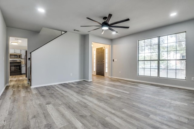 1004 Brae Loch Dr, Dallas, TX 75217 - unfurnished living room featuring ceiling fan, light wood-style floors, and recessed lighting