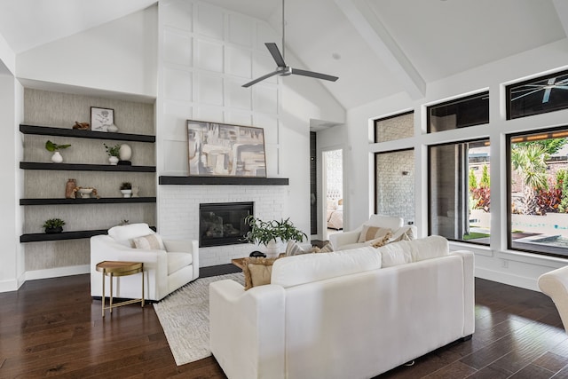8990 Frostweed Rd, Frisco, TX 75035 - living area featuring high vaulted ceiling, a ceiling fan, dark wood-style flooring, a brick fireplace, and beamed ceiling