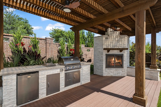 8990 Frostweed Rd, Frisco, TX 75035 - deck featuring an outdoor stone fireplace, a ceiling fan, and area for grilling