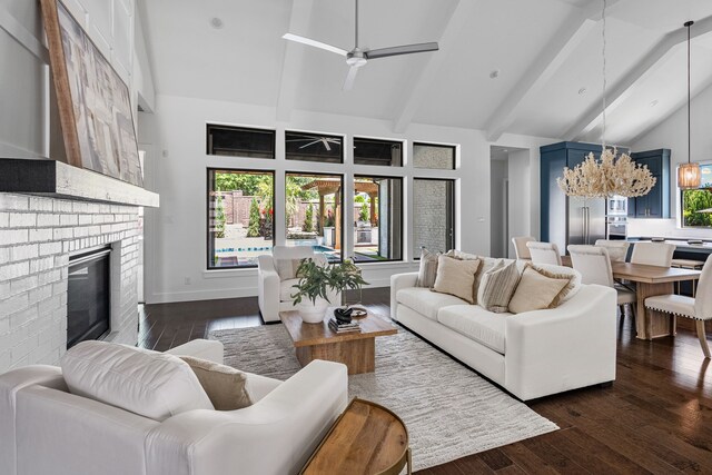 8990 Frostweed Rd, Frisco, TX 75035 - living area featuring high vaulted ceiling, ceiling fan, dark wood-style floors, a brick fireplace, and beamed ceiling
