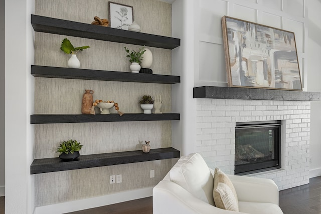 8990 Frostweed Rd, Frisco, TX 75035 - living area featuring dark wood-type flooring and a fireplace