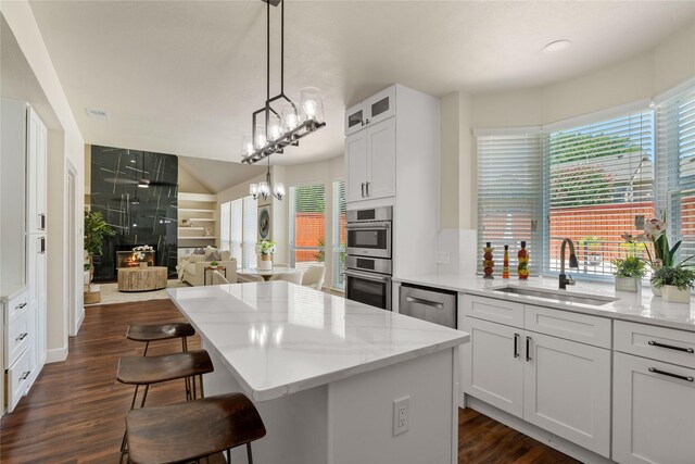 2124 Sandell Dr, Grapevine, TX 76051 - kitchen with appliances with stainless steel finishes, plenty of natural light, a center island, and light stone counters