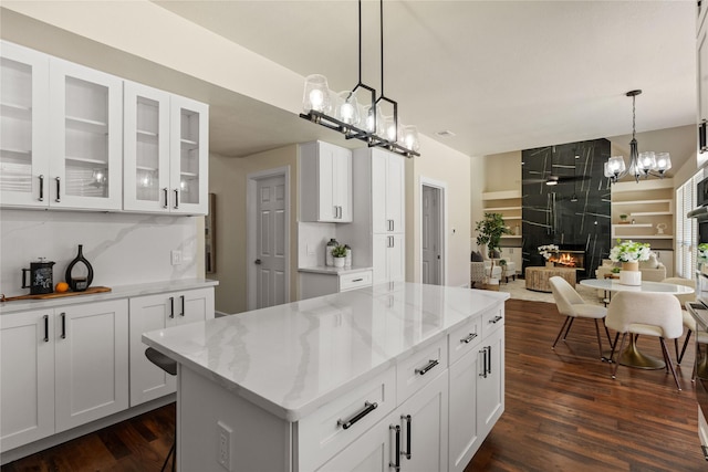 2124 Sandell Dr, Grapevine, TX 76051 - kitchen with dark wood finished floors, a chandelier, and light stone countertops