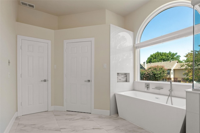 2124 Sandell Dr, Grapevine, TX 76051 - bathroom featuring a freestanding bath and marble finish floors
