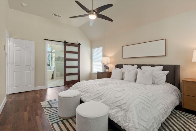2124 Sandell Dr, Grapevine, TX 76051 - bedroom featuring a barn door, multiple windows, vaulted ceiling, wood finished floors, and ensuite bathroom