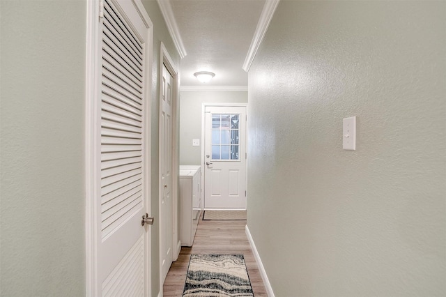 3025 Friendswood Dr, Arlington, TX 76013 - hall featuring ornamental molding, light wood-style floors, washer / dryer, and a textured wall