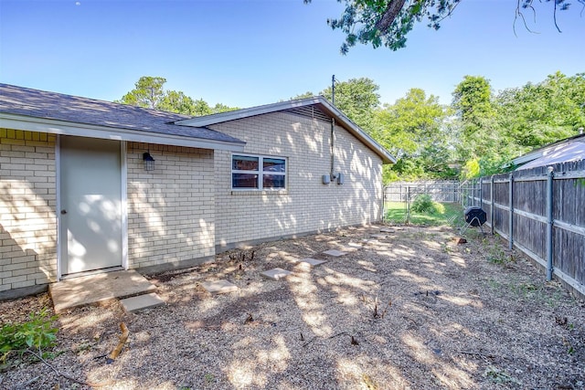 3025 Friendswood Dr, Arlington, TX 76013 - rear view of house with a fenced backyard, brick siding, and a shingled roof