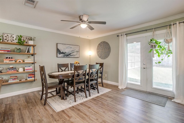 3025 Friendswood Dr, Arlington, TX 76013 - dining space with wood finished floors, ornamental molding, a ceiling fan, and french doors