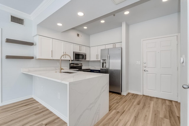 3102 Kings Rd Unit 2104, Dallas, TX 75219 - kitchen featuring stainless steel appliances, open shelves, a peninsula, light wood-style floors, and ornamental molding