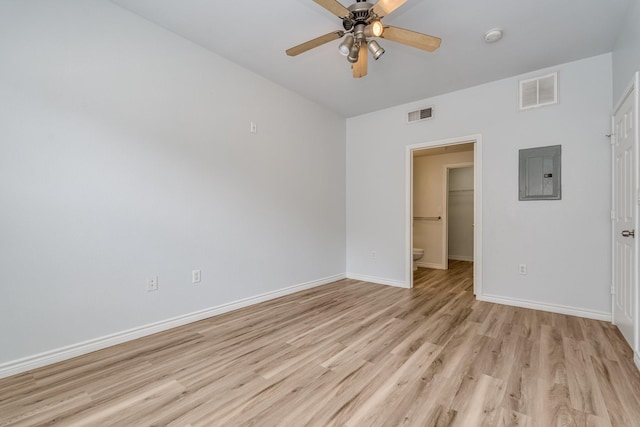 3102 Kings Rd Unit 2104, Dallas, TX 75219 - unfurnished room featuring electric panel, light wood-type flooring, a ceiling fan, and a smoke detector