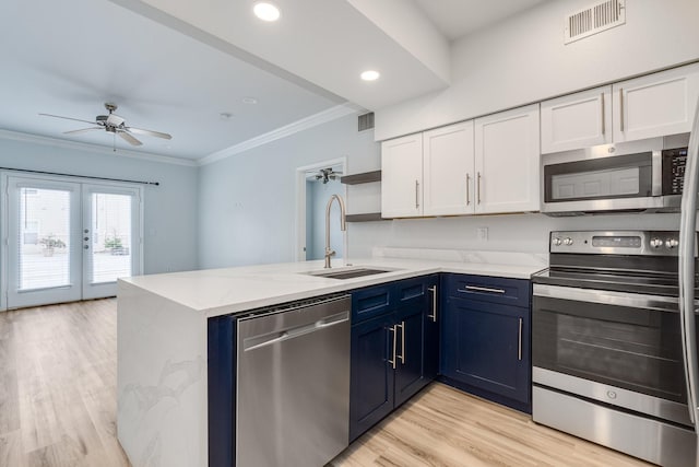 3102 Kings Rd Unit 2104, Dallas, TX 75219 - kitchen featuring appliances with stainless steel finishes, white cabinets, open shelves, ceiling fan, and ornamental molding