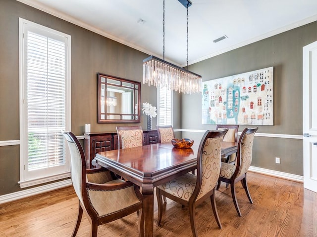5909 Fossil Ridge Dr, Plano, TX 75093 - dining space with wood finished floors, plenty of natural light, a chandelier, and crown molding