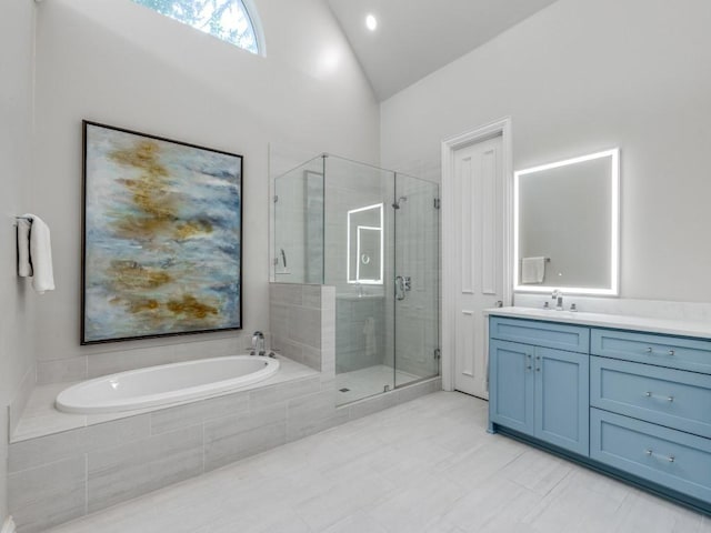 5909 Fossil Ridge Dr, Plano, TX 75093 - full bathroom with a garden tub, a shower stall, vanity, vaulted ceiling, and tile patterned floors