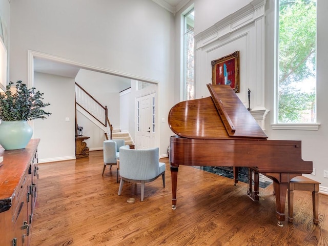 5909 Fossil Ridge Dr, Plano, TX 75093 - living area with light wood-type flooring, plenty of natural light, stairway, and ornamental molding