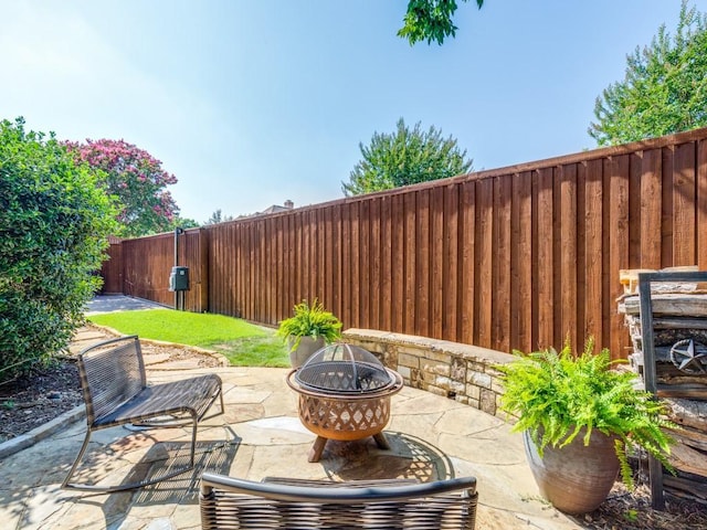 5909 Fossil Ridge Dr, Plano, TX 75093 - fenced backyard with an outdoor fire pit and a patio
