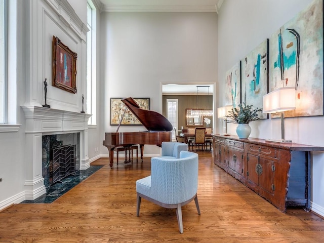 5909 Fossil Ridge Dr, Plano, TX 75093 - living area with a premium fireplace, light wood-style floors, plenty of natural light, and ornamental molding