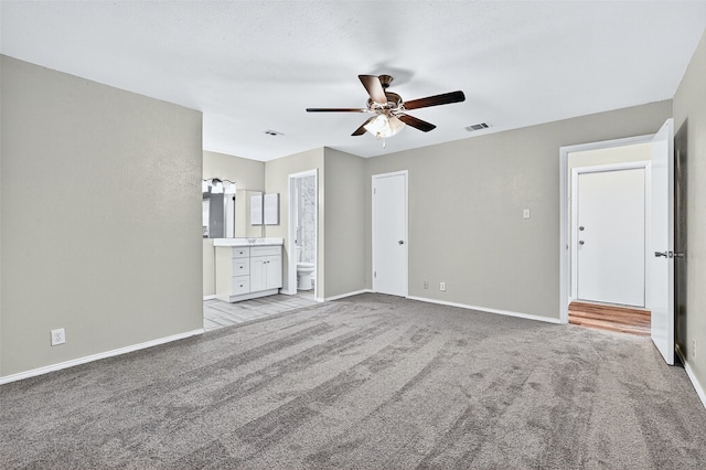 3214 N Marseille Ln, Sherman, TX 75090 - unfurnished bedroom featuring light colored carpet, connected bathroom, and a ceiling fan