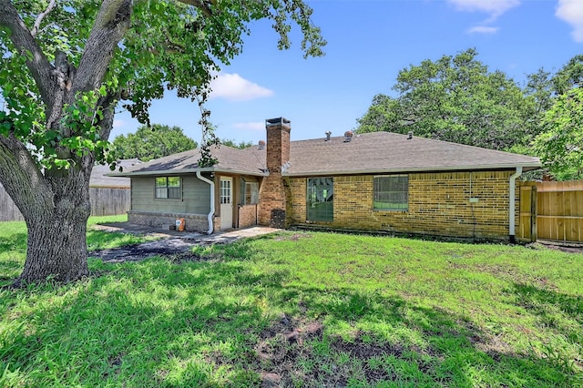 3214 N Marseille Ln, Sherman, TX 75090 - back of house with brick siding, a chimney, and a shingled roof
