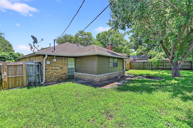 3214 N Marseille Ln, Sherman, TX 75090 - back of property with a chimney, a fenced backyard, and brick siding