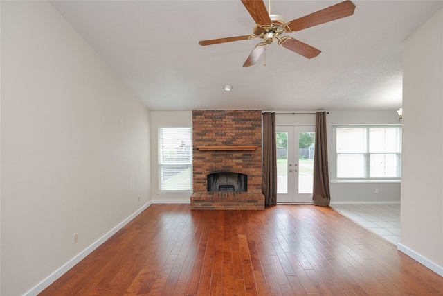 4324 Thames Ct, Flower Mound, TX 75028 - unfurnished living room with plenty of natural light, a brick fireplace, a ceiling fan, and hardwood / wood-style floors