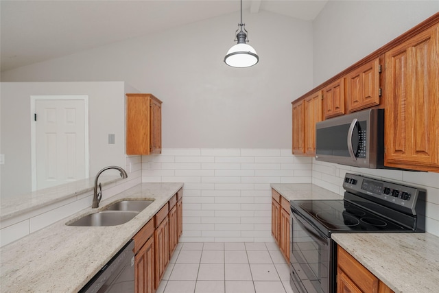 4324 Thames Ct, Flower Mound, TX 75028 - kitchen with appliances with stainless steel finishes, light stone countertops, light tile patterned floors, tile walls, and brown cabinetry