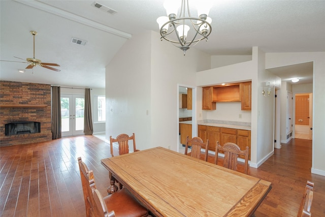4324 Thames Ct, Flower Mound, TX 75028 - dining space featuring lofted ceiling, hardwood / wood-style floors, a ceiling fan, a fireplace, and a chandelier