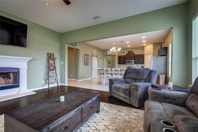 416 Mesa, Lone Oak, TX 75453 - living area with a chandelier, light wood-style flooring, and a fireplace with raised hearth