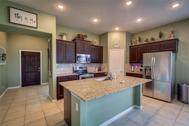 416 Mesa, Lone Oak, TX 75453 - kitchen with appliances with stainless steel finishes, light tile patterned flooring, light stone counters, dark brown cabinetry, and recessed lighting