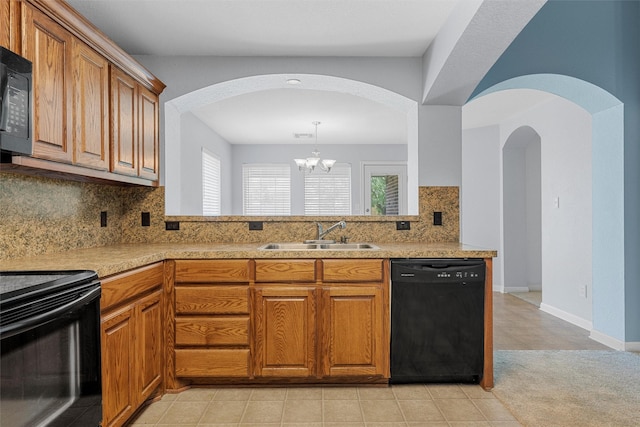 708 Sapphire Blvd, Hewitt, TX 76643 - kitchen with black appliances, arched walkways, brown cabinetry, and tasteful backsplash