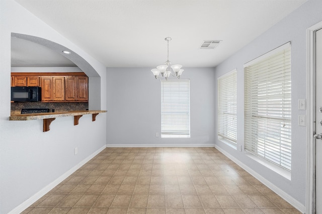 708 Sapphire Blvd, Hewitt, TX 76643 - unfurnished dining area with a chandelier and baseboards