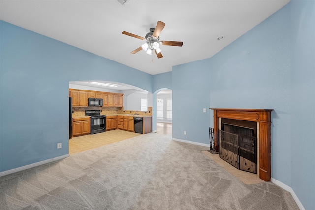 708 Sapphire Blvd, Hewitt, TX 76643 - unfurnished living room featuring arched walkways, ceiling fan, light carpet, and a fireplace with flush hearth