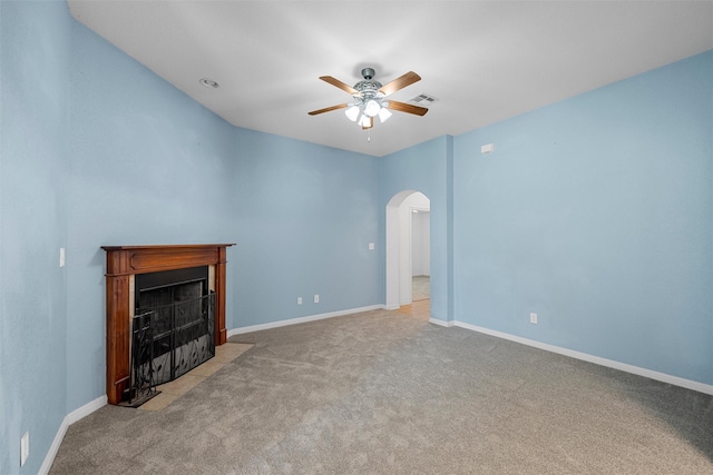 708 Sapphire Blvd, Hewitt, TX 76643 - unfurnished living room featuring arched walkways, a ceiling fan, carpet, and a fireplace with flush hearth