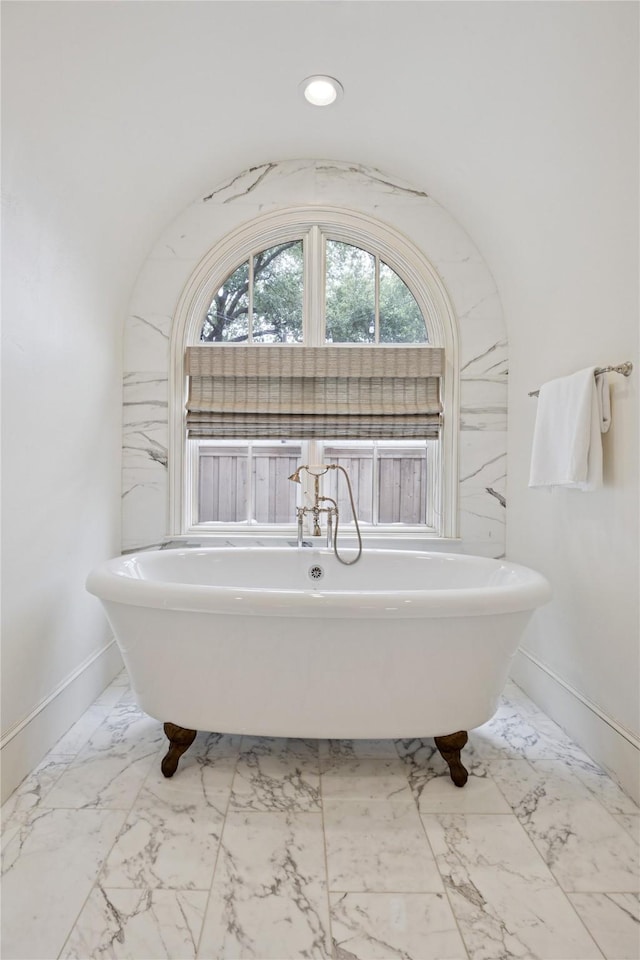 3404 Marquette St, University Park, TX 75225 - full bathroom featuring marble look tile flooring and a soaking tub