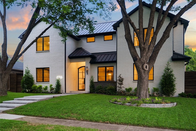 6716 Dalhart Ln, Dallas, TX 75214 - view of front facade with a standing seam roof, a front lawn, and a metal roof