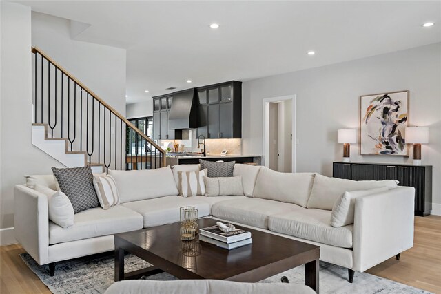 6716 Dalhart Ln, Dallas, TX 75214 - living room with light wood-style flooring, recessed lighting, and stairway