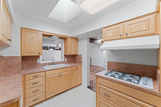 1227 N Irving Heights Dr, Irving, TX 75061 - kitchen featuring under cabinet range hood, light brown cabinets, light flooring, and backsplash