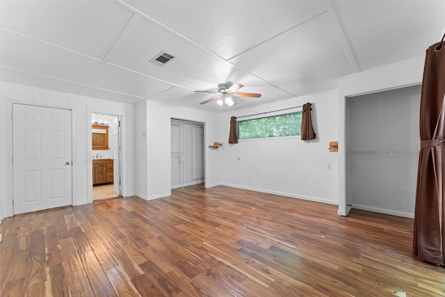 1227 N Irving Heights Dr, Irving, TX 75061 - unfurnished bedroom featuring wood finished floors, ensuite bathroom, and ceiling fan