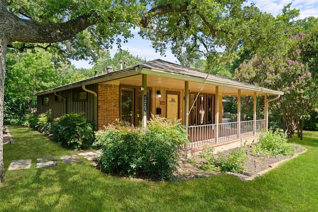 1227 N Irving Heights Dr, Irving, TX 75061 - rear view of house with a lawn and covered porch