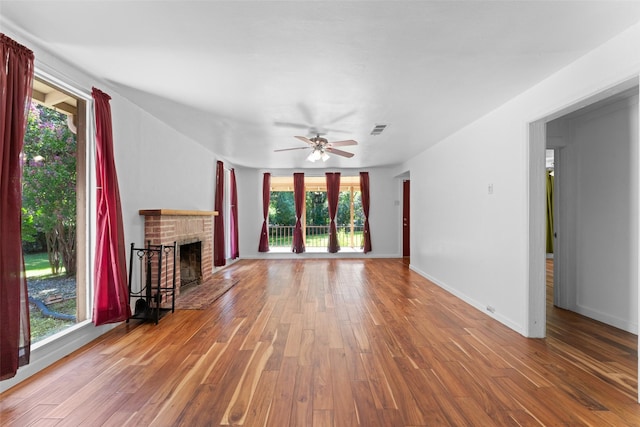1227 N Irving Heights Dr, Irving, TX 75061 - unfurnished living room featuring a fireplace, wood finished floors, and a ceiling fan
