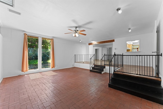 1227 N Irving Heights Dr, Irving, TX 75061 - unfurnished room featuring brick flooring, ceiling fan, and stairs
