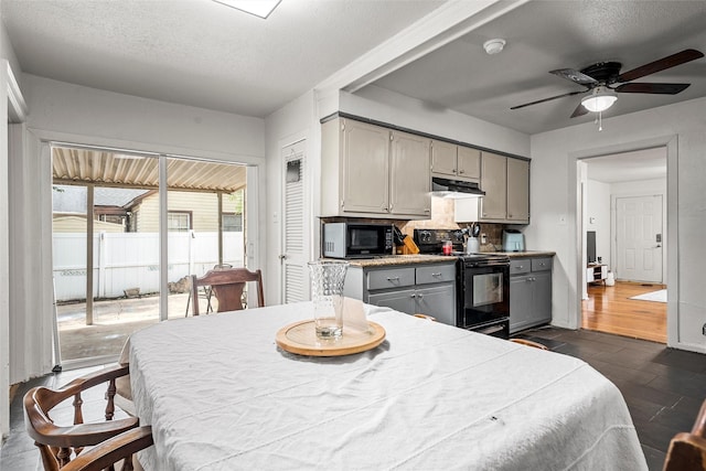 1205 Ashleman St, Bellmead, TX 76705 - kitchen featuring black appliances, gray cabinets, under cabinet range hood, ceiling fan, and dark wood finished floors