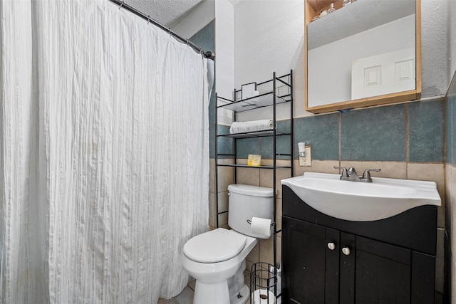 1205 Ashleman St, Bellmead, TX 76705 - full bath with tile walls, vanity, tile patterned floors, a shower with shower curtain, and wainscoting