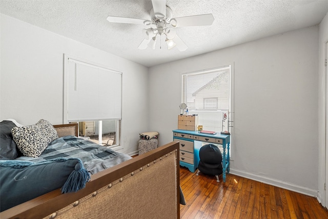 1205 Ashleman St, Bellmead, TX 76705 - bedroom featuring hardwood / wood-style floors, a textured ceiling, and a ceiling fan